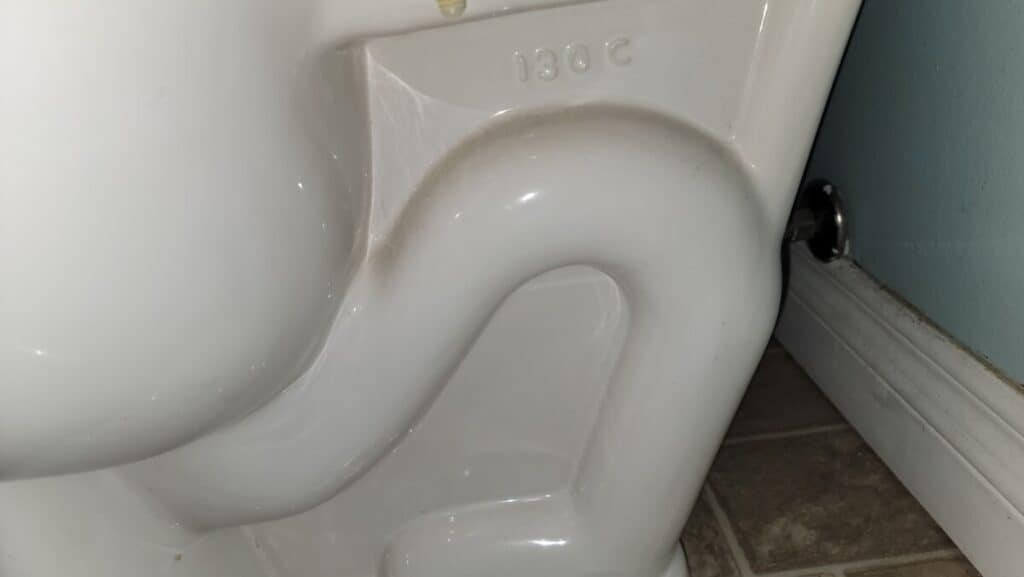 image showing a clogged toilet trap which is causing a weak flush