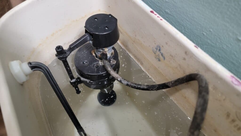 image showing a compromised flush valve which can lead to a slow toilet flush