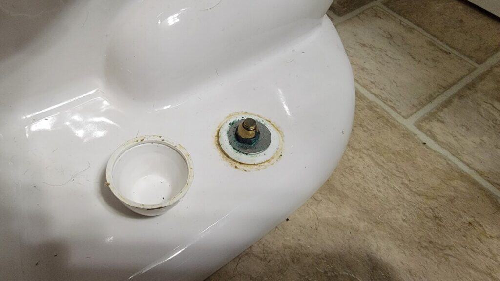 image of loose closet bolts on a toilet and where to locate them