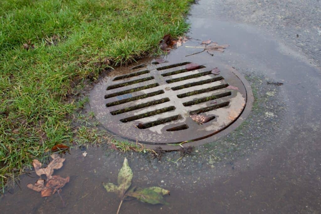 image showing an overloaded storm drain and backed up sewer