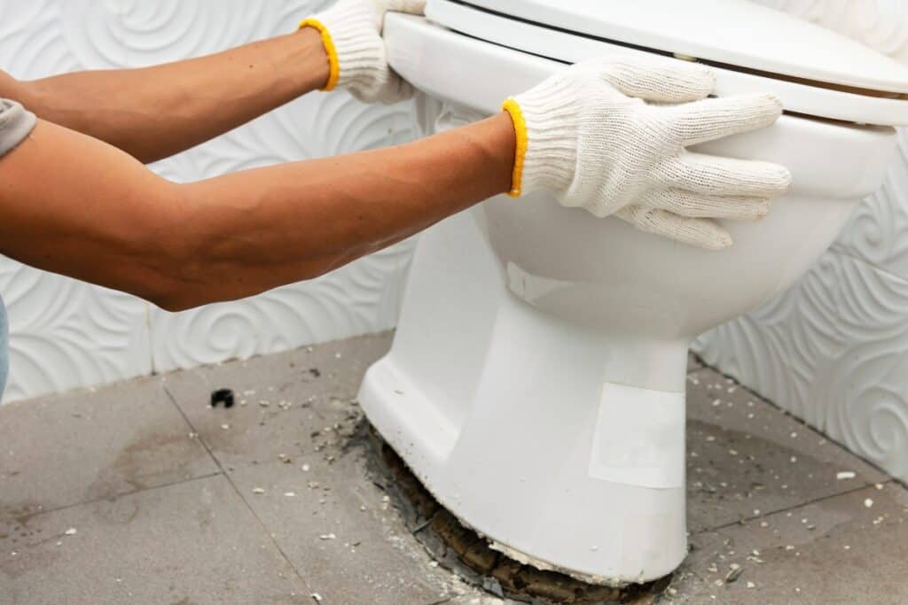 image of a toilet being removed from the floor
